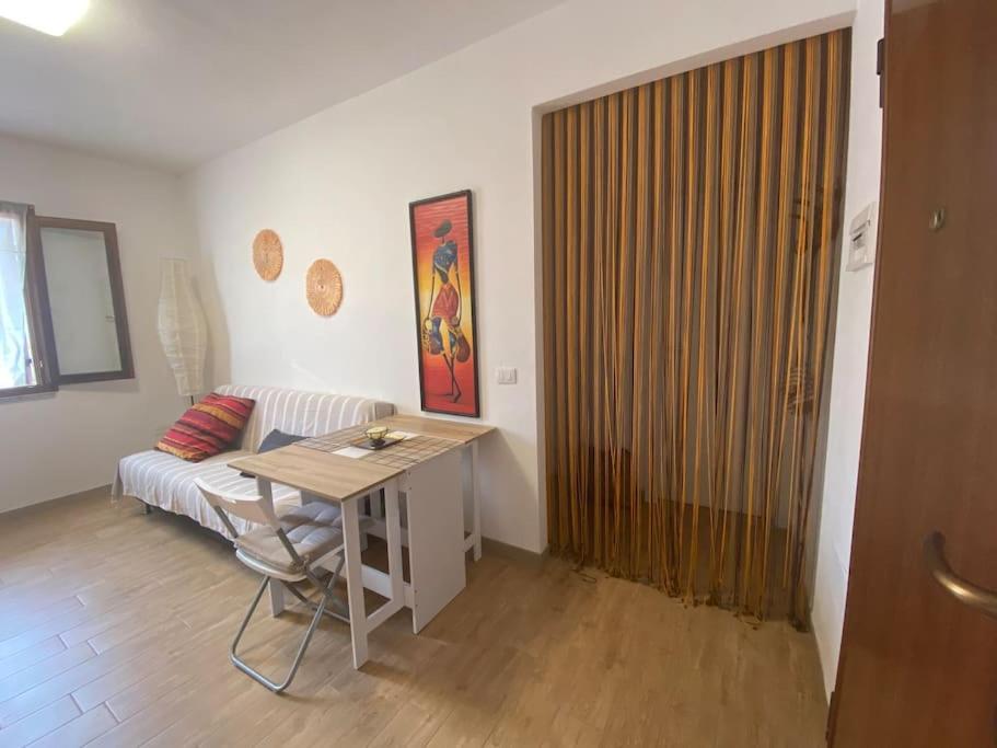 a living room with a table and a couch at Your Exclusive Apartment near Santa Teresa Gallura in Porto Pozzo