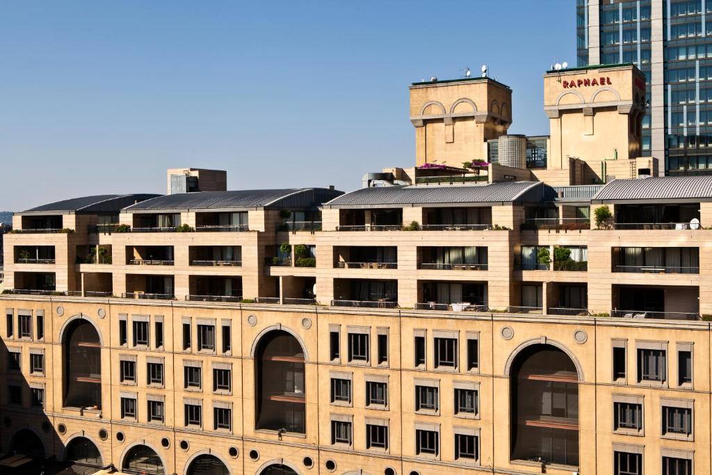 a large building in front of a city at Raphael Suites in Johannesburg