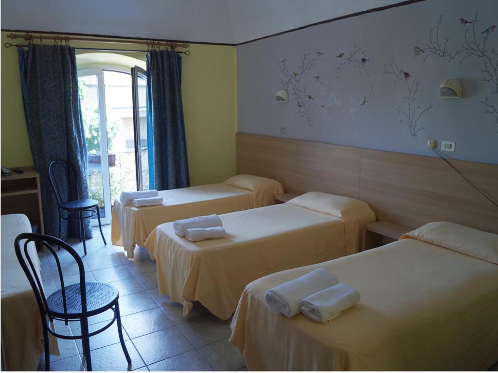 Postel nebo postele na pokoji v ubytování Hotel Stazione