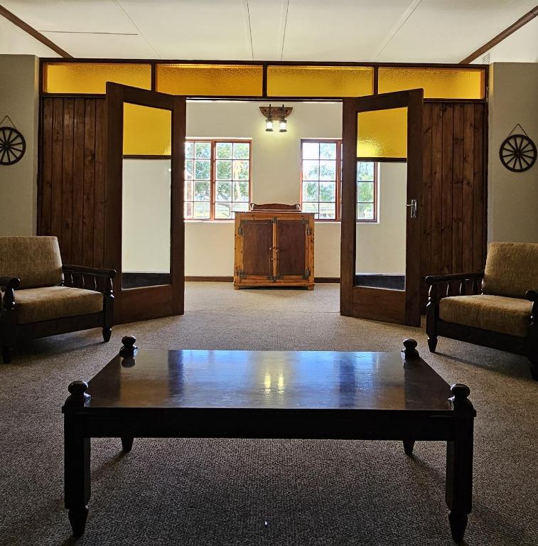 a room with a table in the middle of a room at Leeu Gamka Hotel in Leeu-Gamka