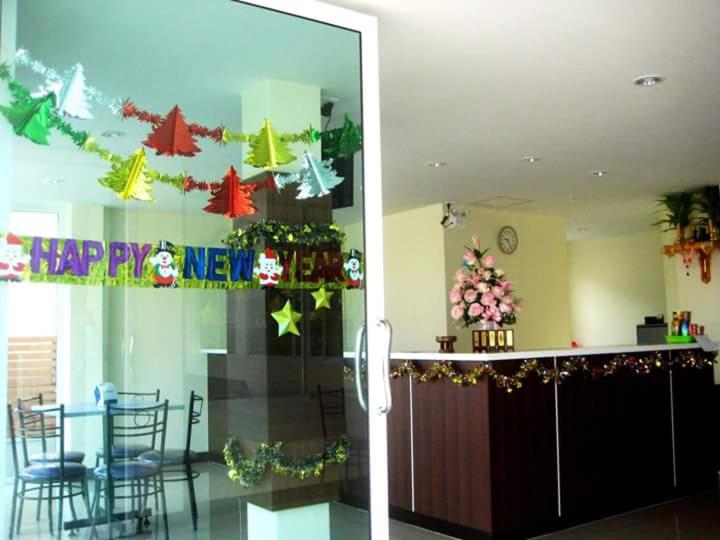 a lobby with a christmas tree on the wall at Baansiri Chiangrai in Chiang Rai