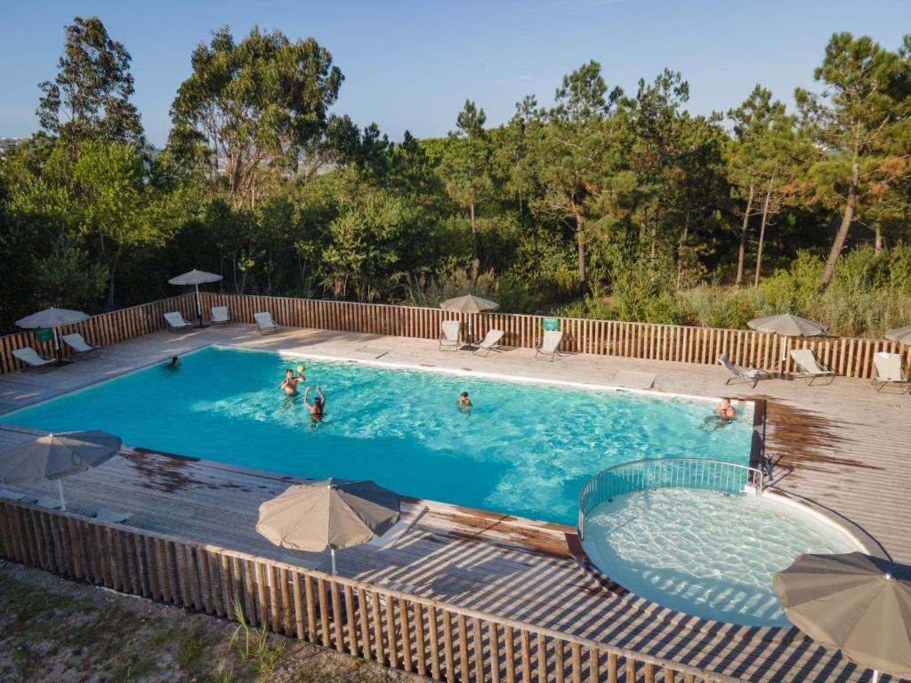 a large swimming pool with people in the water at Huttopia Lagoa de Óbidos in Casal do Narcizo