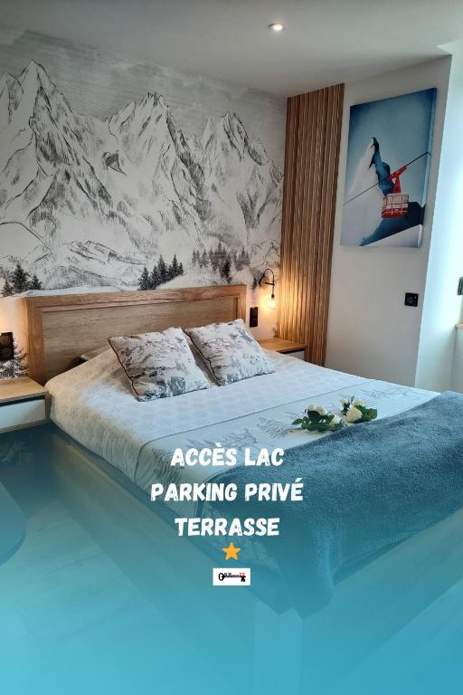 a bedroom with a large bed with a mountain mural at Sublime Studio proche du lac avec parking privé in Viviers-du-Lac