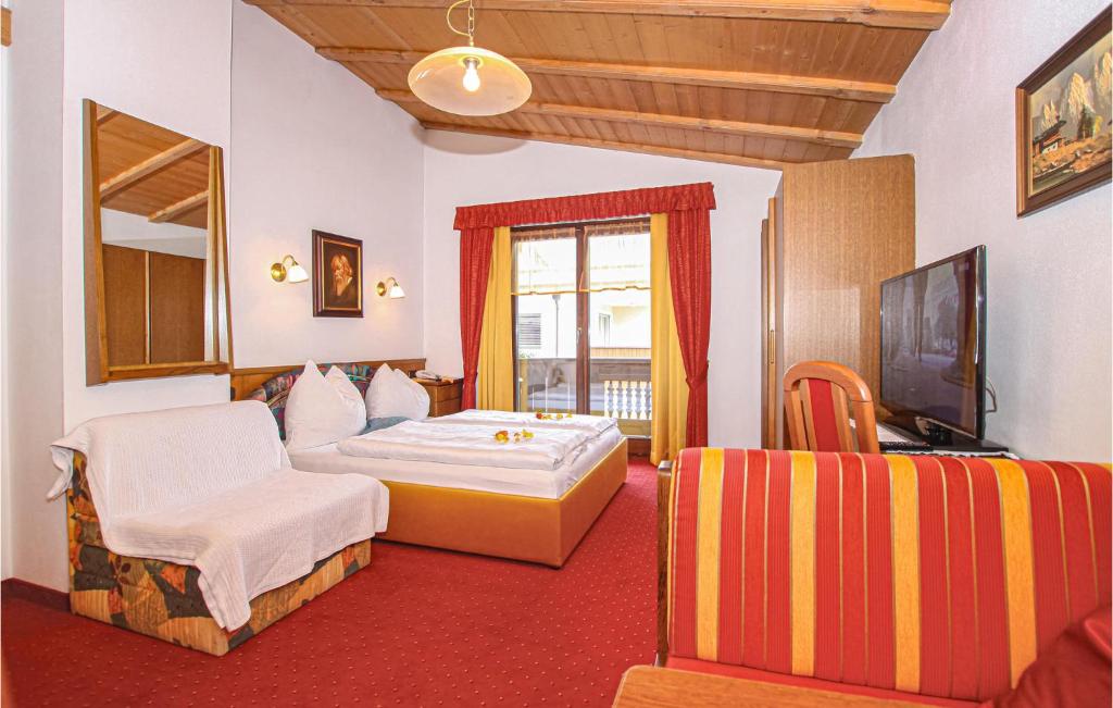 a hotel room with a bed and a television at Ferienwohnung in Kirchberg in Tirol