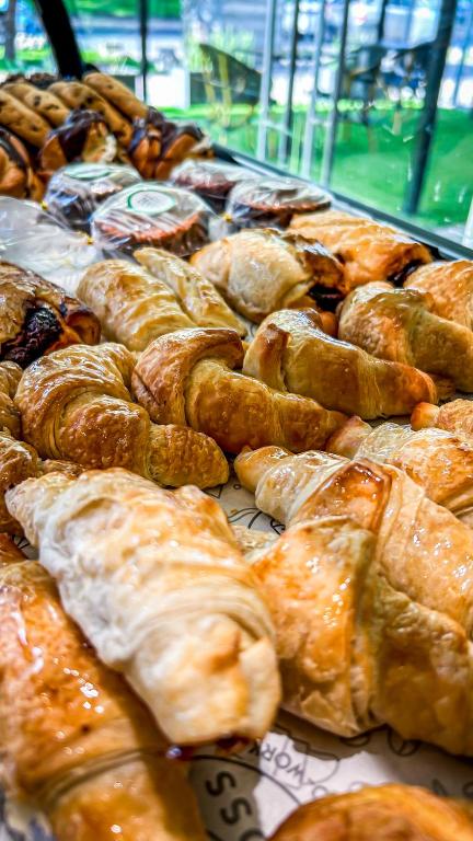 a bunch of pastries on display in a bakery at Ecohotel Talca in Talca