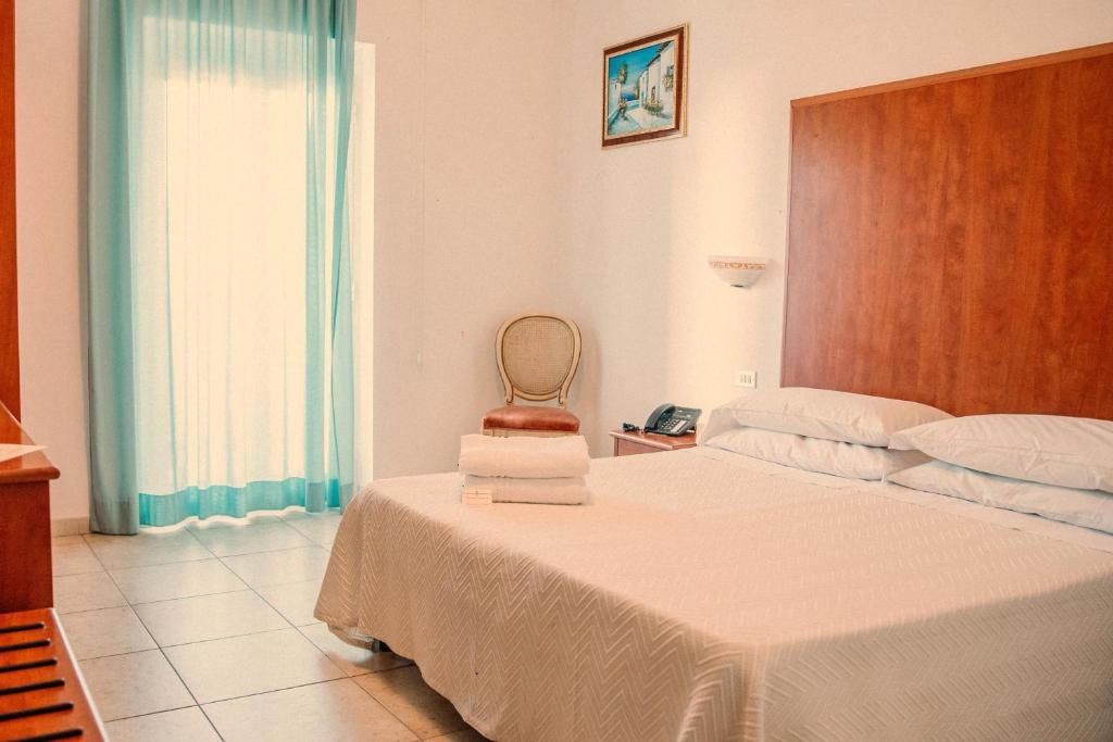 Postel nebo postele na pokoji v ubytování Magnolia Hotel Vieste
