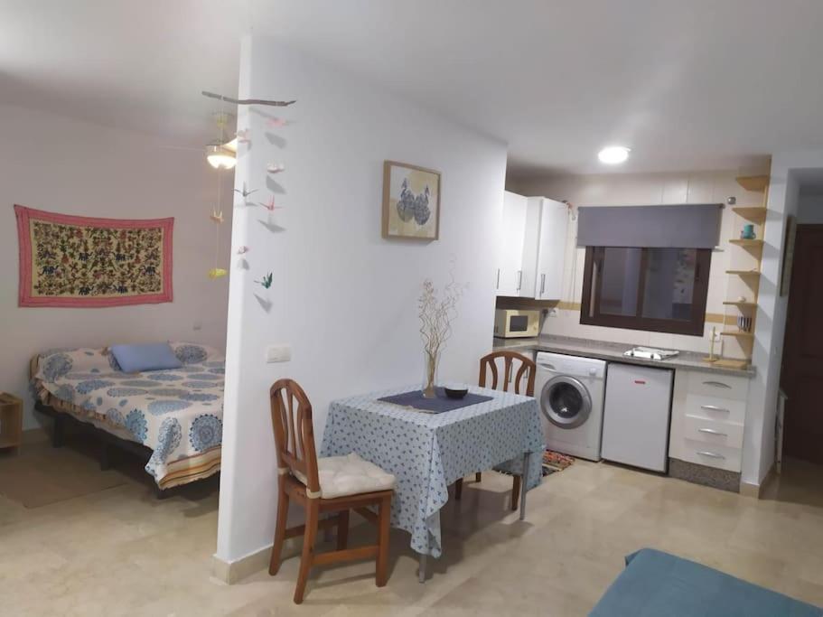 a living room with a table and a kitchen at Eli's Home in Málaga