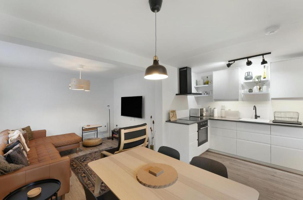 a kitchen and a living room with a table in a room at Mulberry in Bowness-on-Windermere