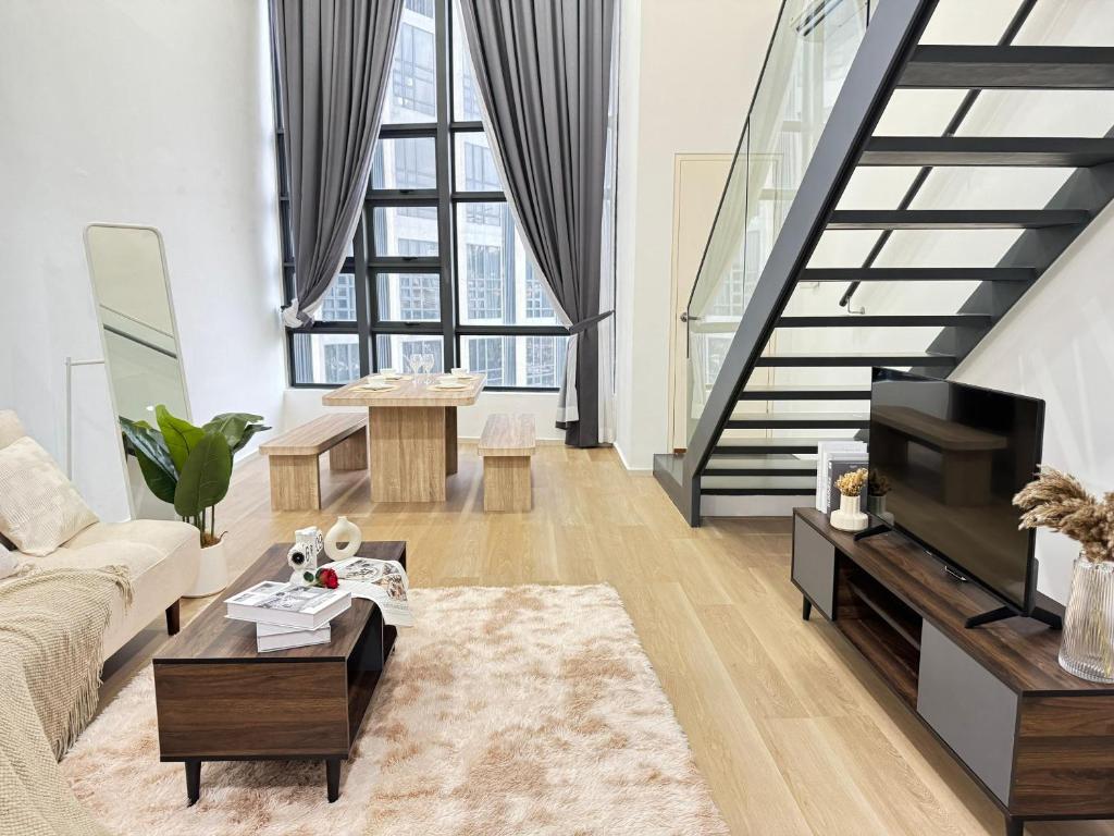 a living room with a couch and a tv at Urban Loft MRT Convenience KLCC Nearby in EKO CHERAS in Kuala Lumpur
