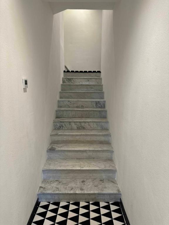 a stairway with a black and white checkered floor at Re Versiliana Hotel in Marina di Pietrasanta