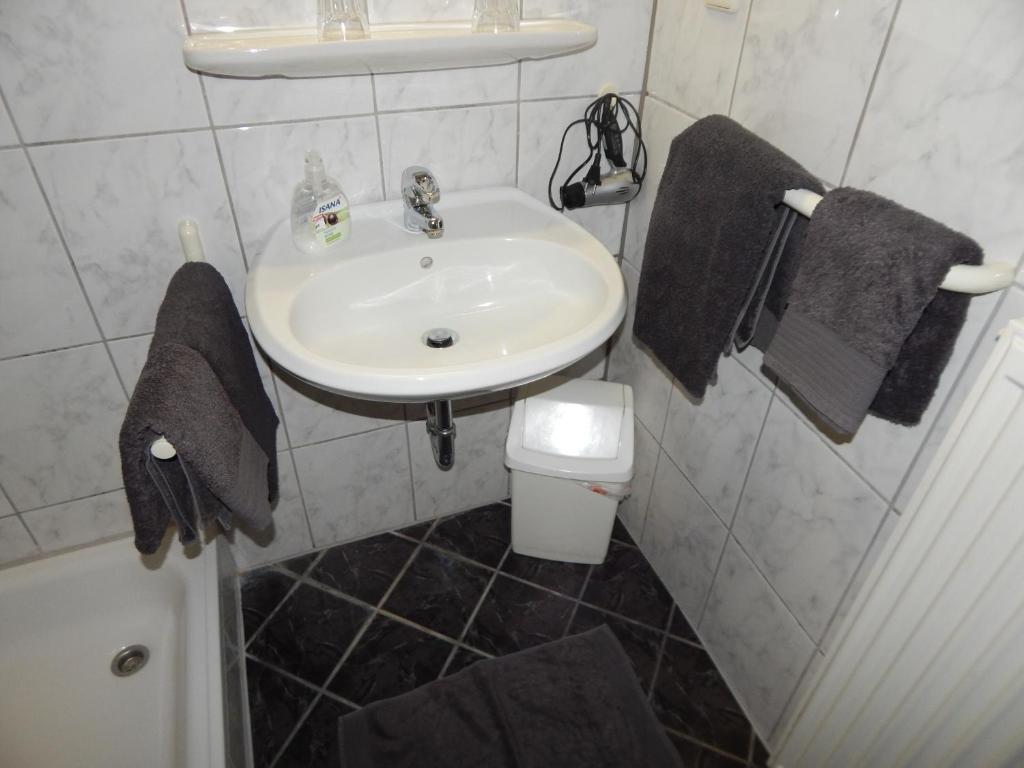 a bathroom with a sink and a toilet at Haus Hilde in Norderney