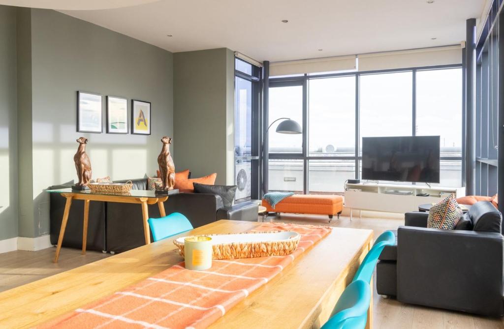 a living room with a couch and a table at GuestReady - Enchanting views from Millenium Tower in Dublin