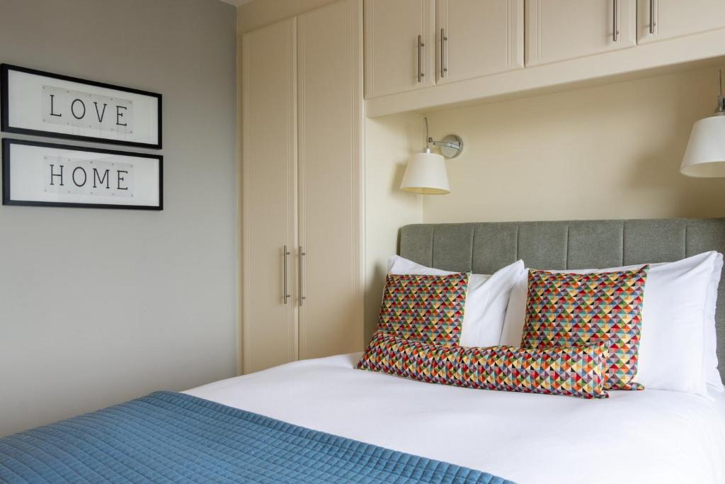 a bedroom with a bed with two pillows on it at GuestReady - Enchanting views from Millenium Tower in Dublin