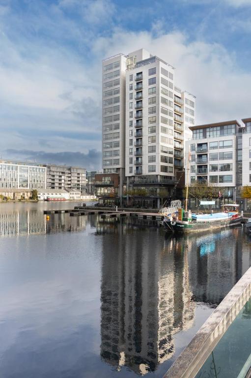 a city with tall buildings next to a body of water at GuestReady - Enchanting views from Millenium Tower in Dublin