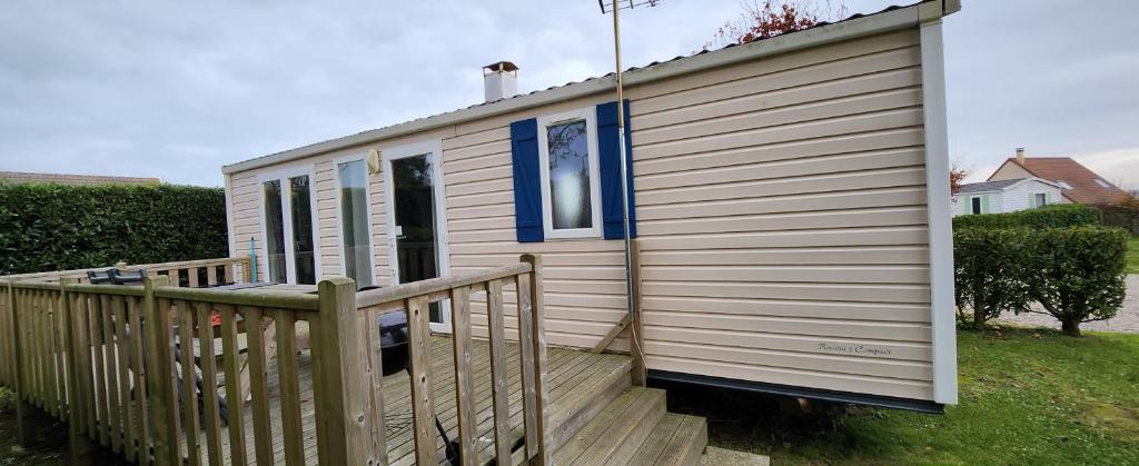 a small house with a wooden ramp next to a house at jurfftyg in Biville-sur-Mer