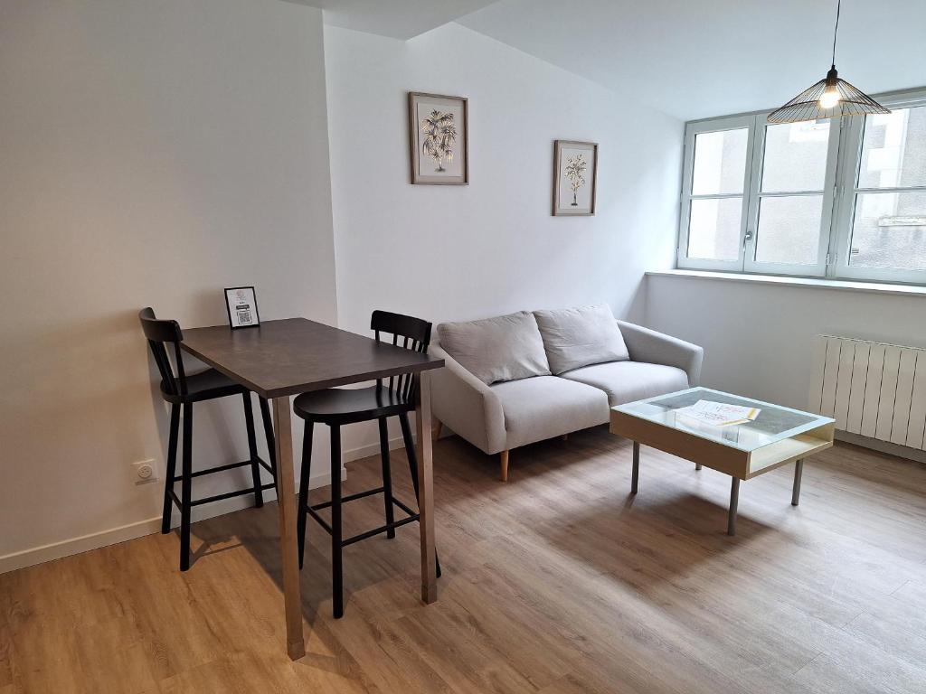un salon avec une table et un canapé dans l'établissement Notre Dame 4 - 50m bords de Loire - Hypercentre - Très lumineux, à Orléans
