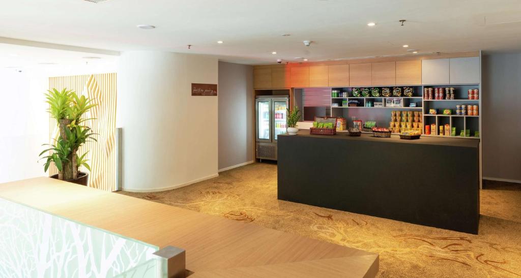 A compact lobby counter offers packaged drinks and snacks beside a small service area.