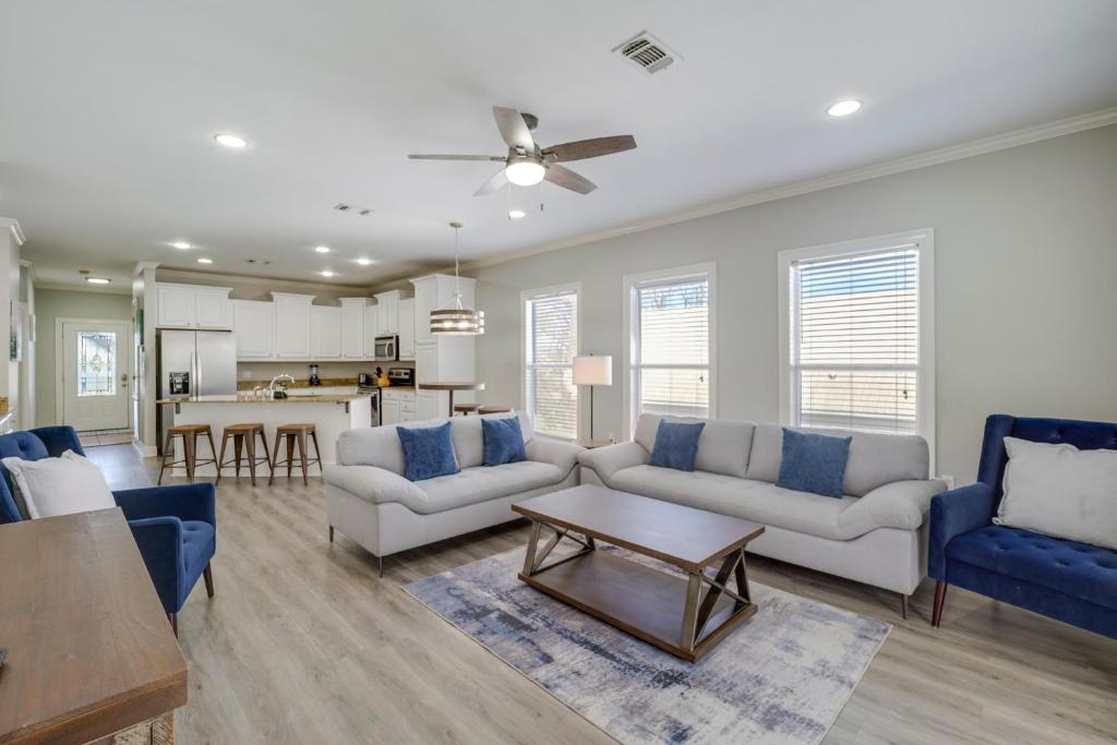 a living room with two couches and a table at Relaxing Biloxi Vacation Rental Condo Near Beach! in Biloxi