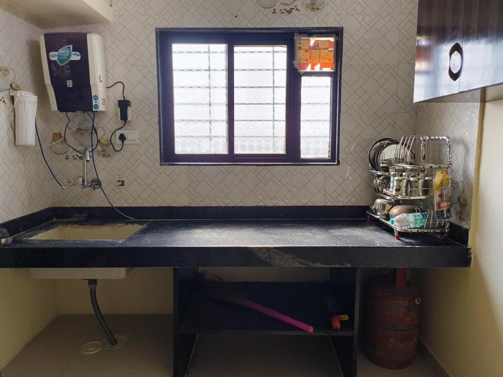 Kuchyň nebo kuchyňský kout v ubytování 1BHK Cozy Stay