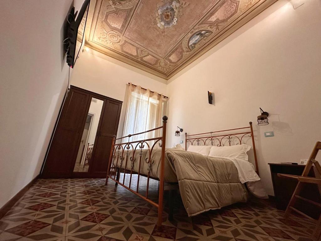 a bedroom with a bed and a coffered ceiling at Calvino Home in Trapani