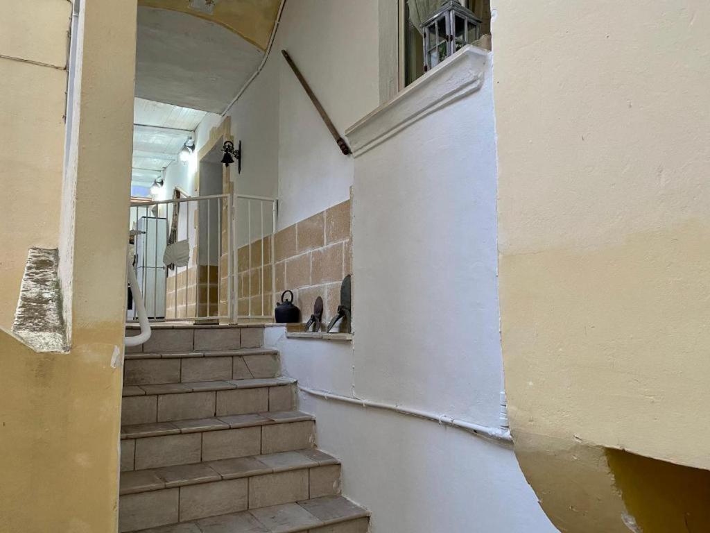a stairway in a building with stairs and a window at Suite Carmen in Gallipoli