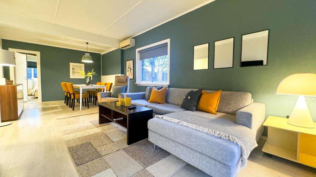 a living room with a couch and a table at Cozy apartment with free parking in Jar