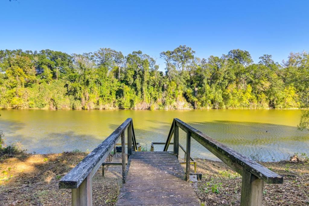a wooden bridge over a body of water at Riverfront Fishing Home in Columbus with Grill in Columbus