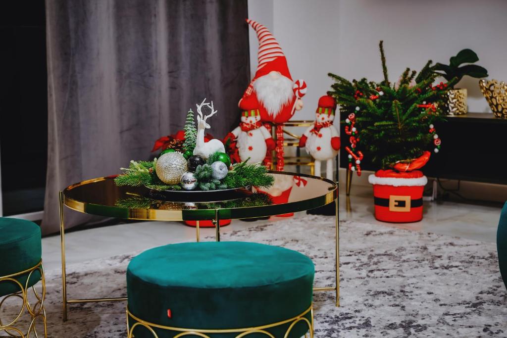a living room with a table with christmas decorations at Nowoczesne Apartamenty typu Superior - Bulwary Rabka Zdrój - Balia - Blisko Park Zdrojowy in Rabka