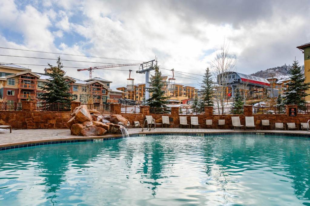 a swimming pool at a resort with a fountain at The Grand Summit Hotel in the Canyons Village - Walk to Ski Lift - Pool, Gym, Spa, More! in Park City