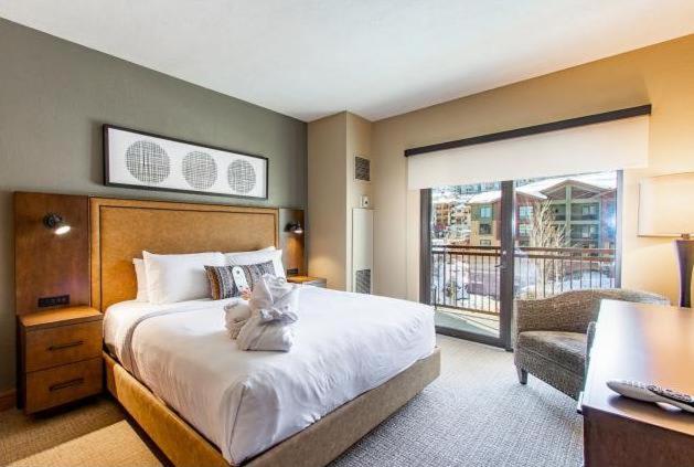 a bedroom with a large bed and a balcony at Grand Summit Hotel, Ski In Out, Pool, Hot Tub, Gym, Perfect Location! in Park City