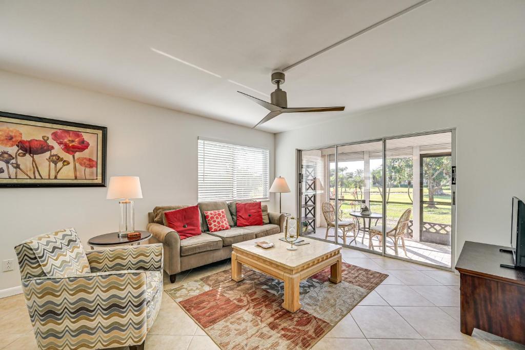 a living room with a couch and a table at Lanai and Golf Course View Cozy Condo in Naples! in Naples