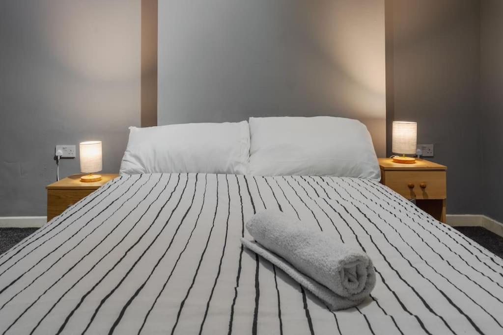 a white bed with a towel on top of it at Serviced Accommodation Liverpool by Tomla- Free Parking in Liverpool