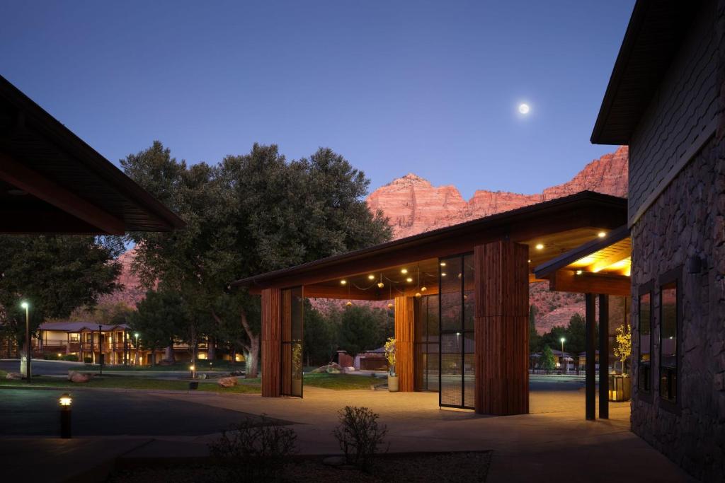 a building with a mountain in the background at The Red Cliffs Lodge Zion, a Tribute Portfolio Hotel in Springdale