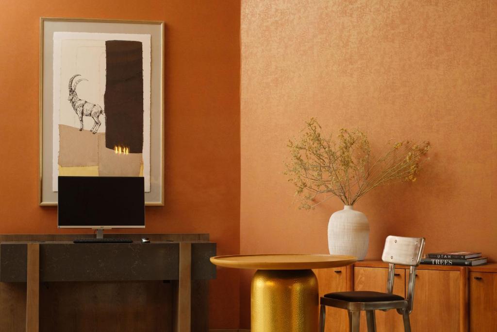 a room with a table and a table with a vase at The Red Cliffs Lodge Zion, a Tribute Portfolio Hotel in Springdale