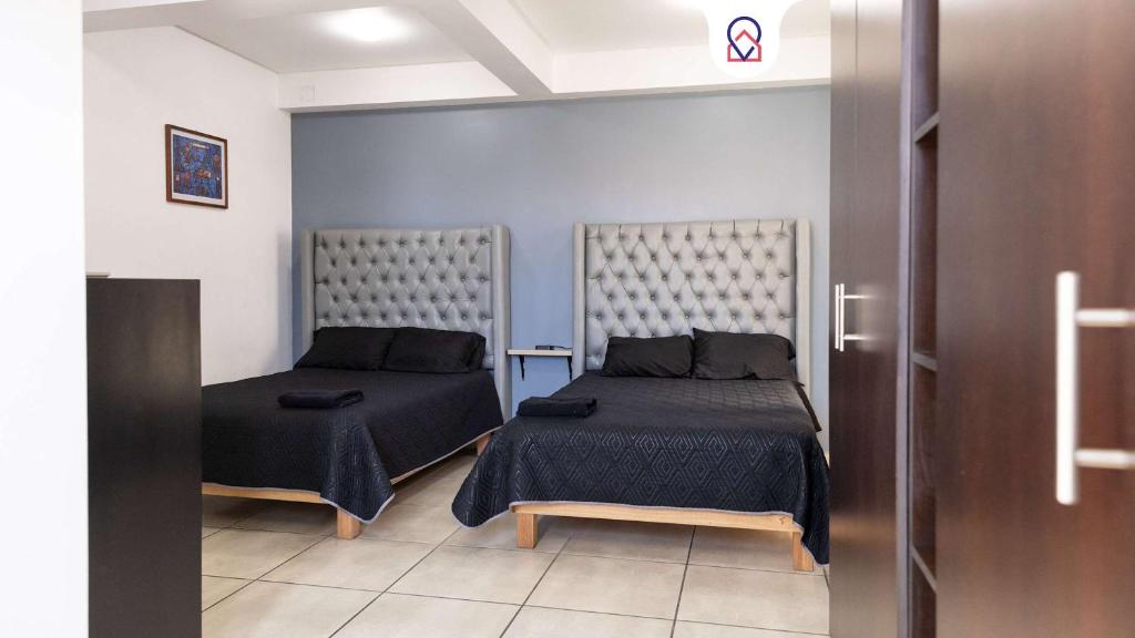 a bedroom with two beds in a room at Family House with 4 Bedrooms Oaxaca in Oaxaca City