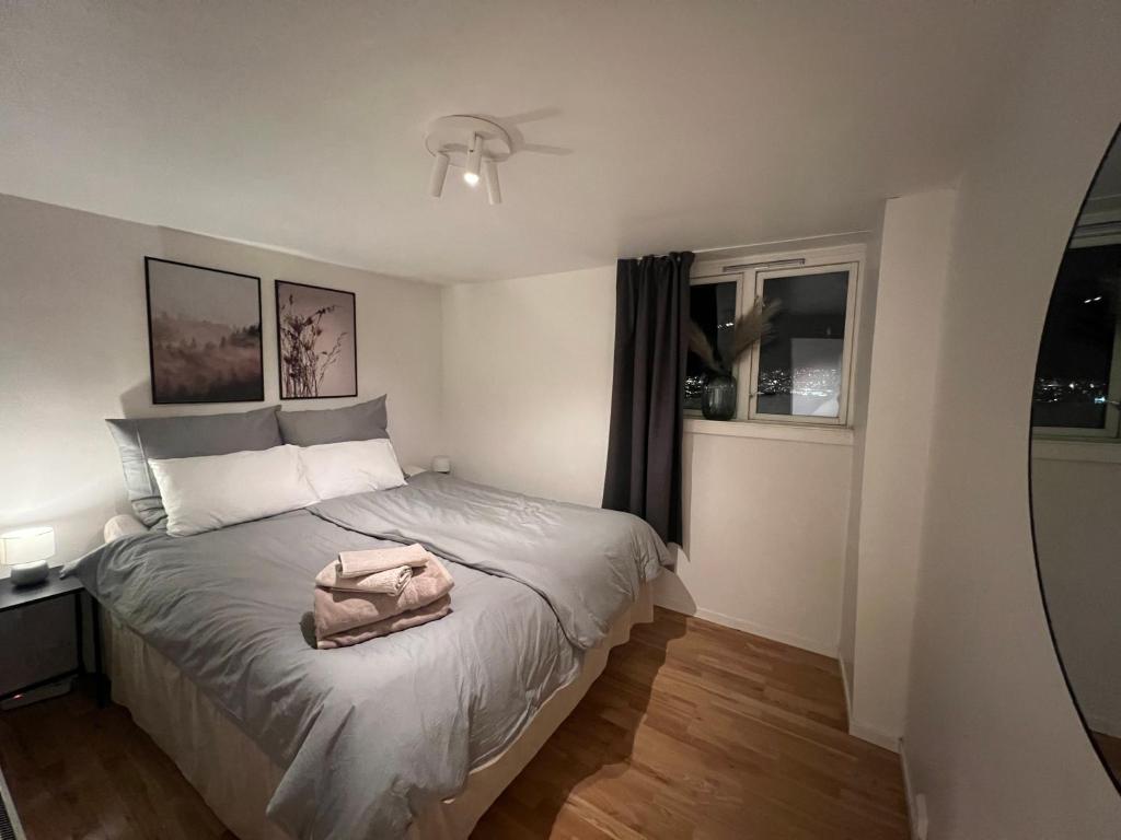 a bedroom with a bed with a towel on it at Polar - TAG-apartments in Tromsø