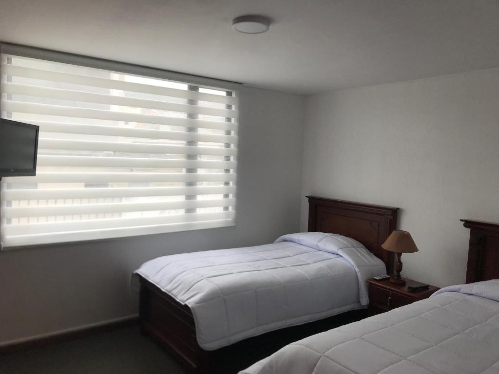 Postel nebo postele na pokoji v ubytování Altura Rooms & Suites