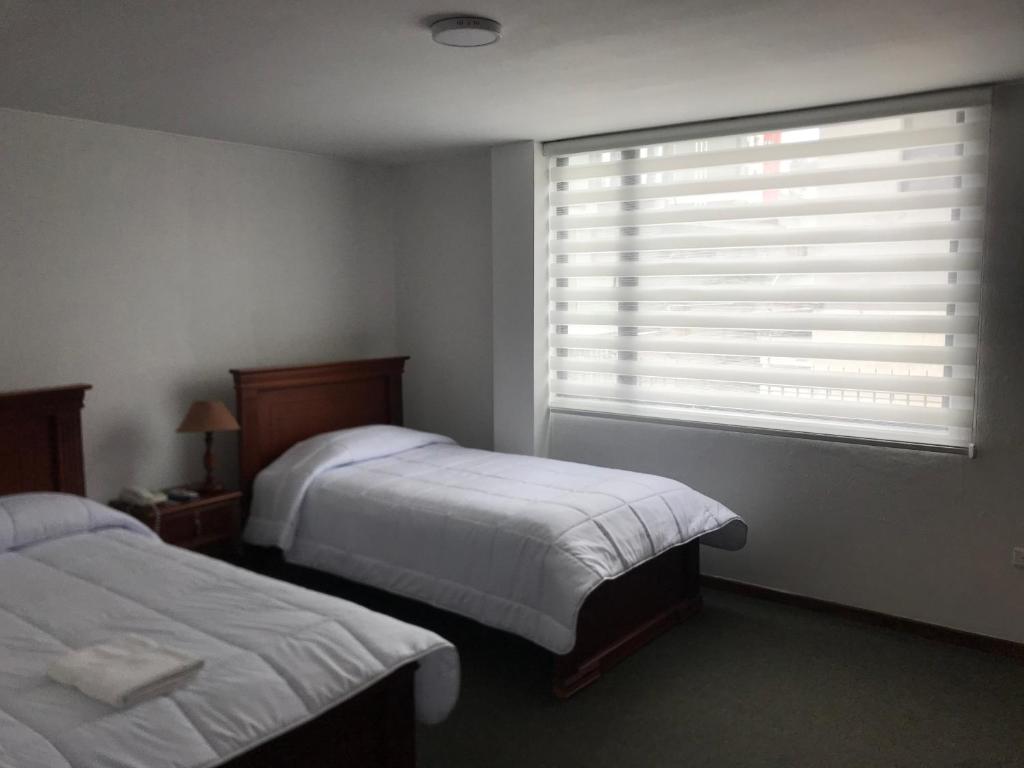 Postel nebo postele na pokoji v ubytování Altura Rooms & Suites