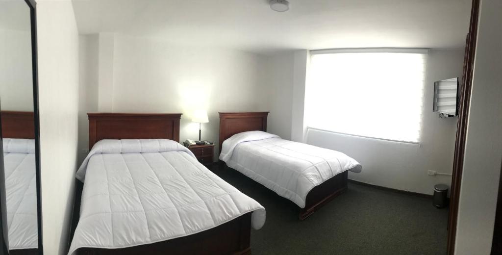 Postel nebo postele na pokoji v ubytování Altura Rooms & Suites