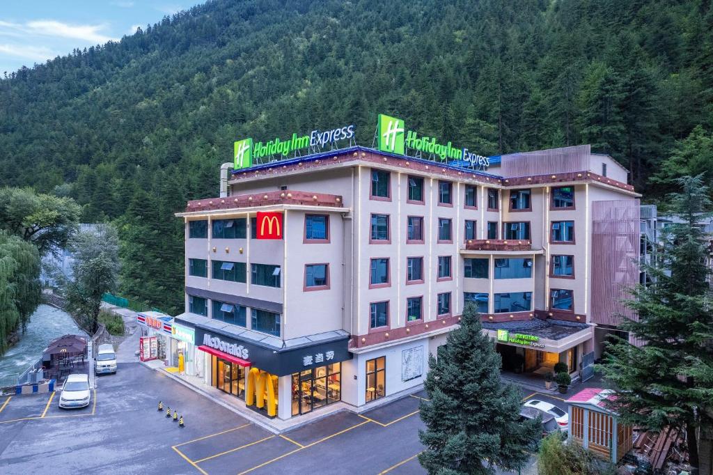 an aerial view of a hotel with a parking lot at Holiday Inn Express Jiuzhaigou in Jiuzhaigou