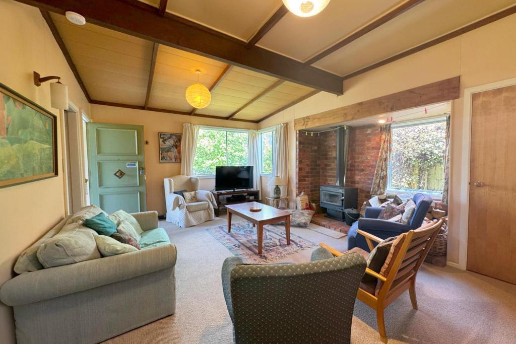 a living room with a couch and a table at 8 Leamington Street in Hanmer Springs