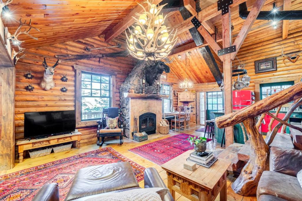a living room with a fireplace and a tv at about 13 Mi to Main St Park City Cabin with Mtn Views! in Park City