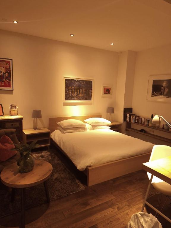 a bedroom with a large bed and a table at Great room in cool house in York