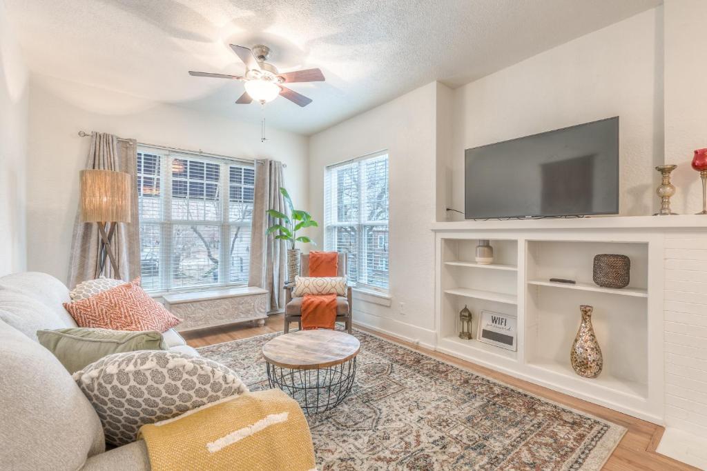 a living room with a couch and a tv at Carson Flats Apt 3 - 1BR Near BOK, OSU Med, Dtwn in Tulsa