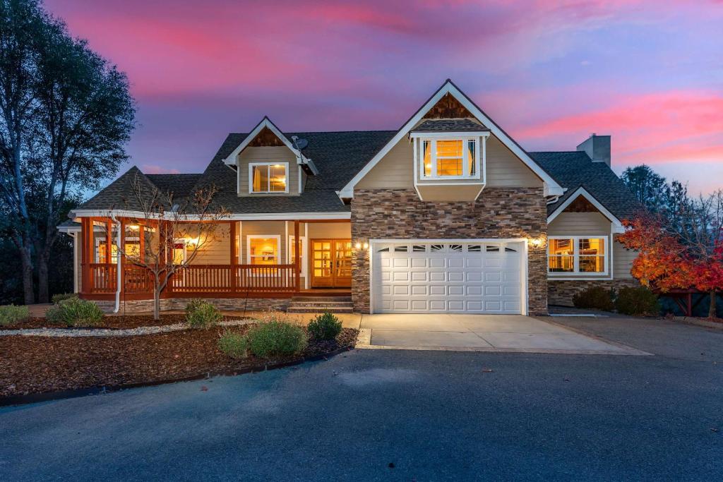 a house with a garage in front of it at Luxury Lodge-Hot Tub-BBQ-Sleeps 18 in Oakhurst