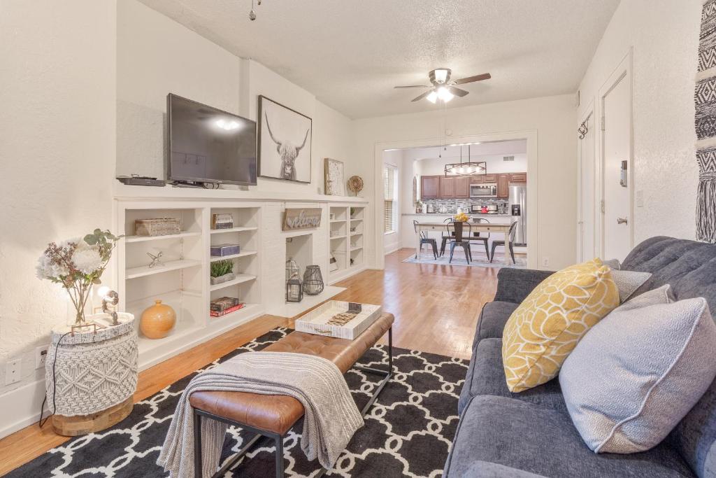 a living room with a blue couch and a table at Carson Flats Apt 5 - 1BR Near BOK, OSU Med, Dtwn in Tulsa