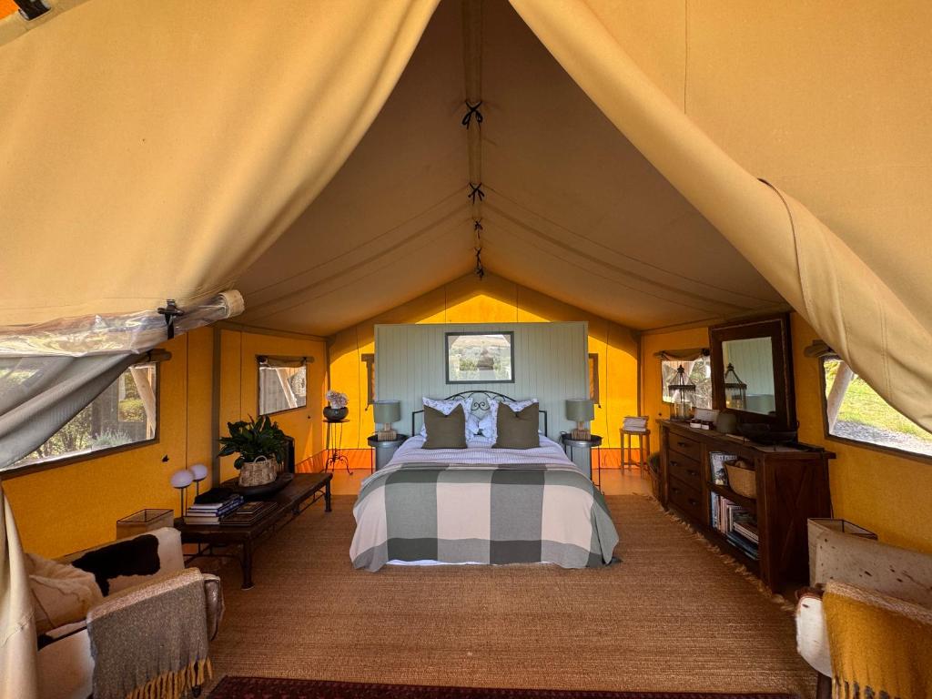 a bedroom with a bed in a tent at Tuki Glamping in Havelock North