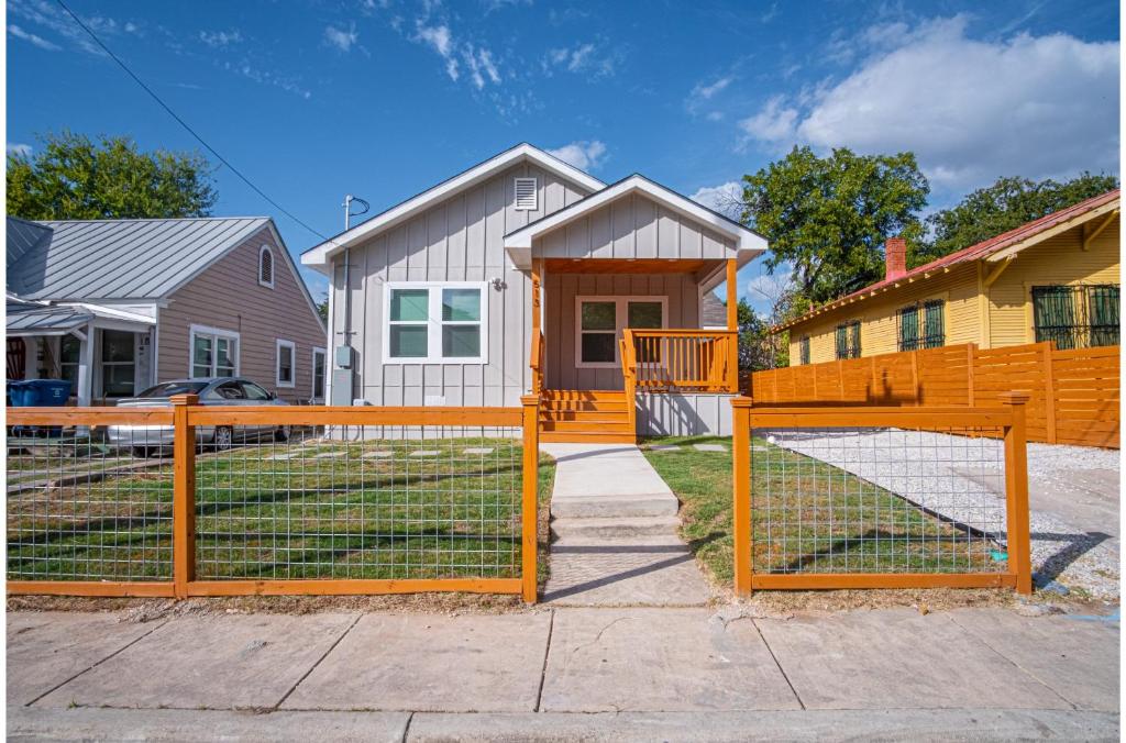 a wooden fence in front of a house at Lovely Charming 4BR2.5BA Near Downtowns Prime in San Antonio