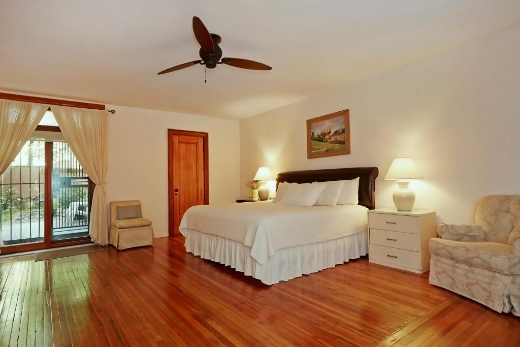 a bedroom with a bed and a ceiling fan at Home NYC in New York