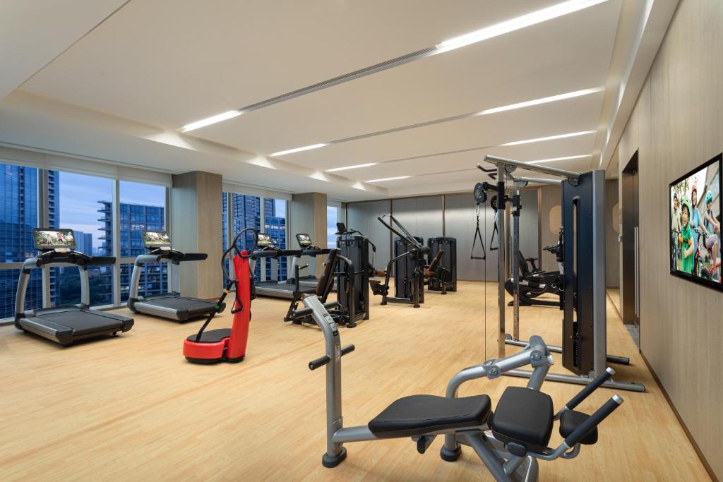 a gym with cardio equipment in a hotel room at Somerset QPlex Shenzhen in Shenzhen